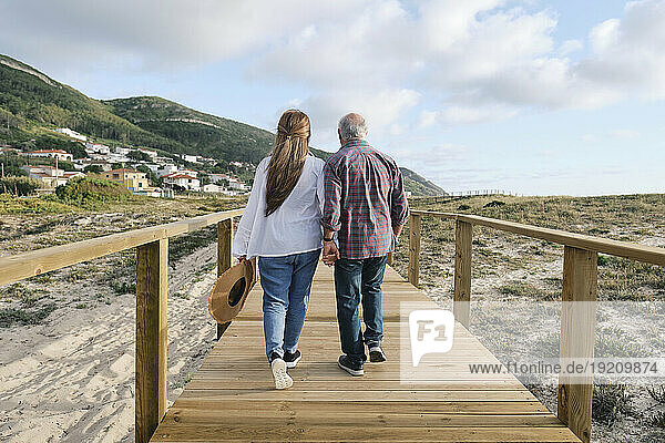 Couple together walking on boardwalk