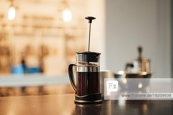 French press coffee maker on table at home