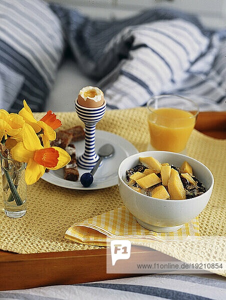 Breakfast tray with muesli  boiled egg and orange juice