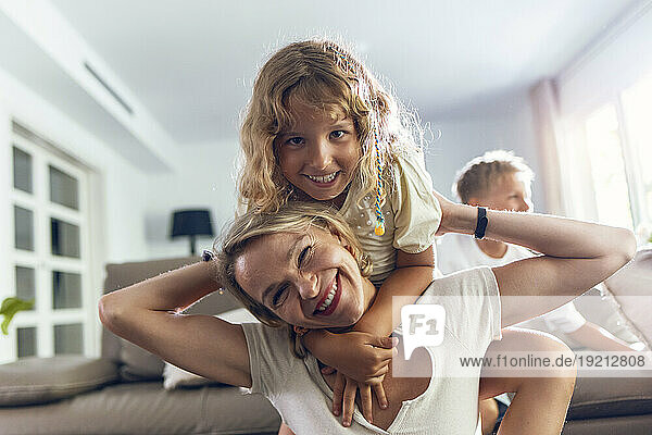 Happy mother with daughter in living room