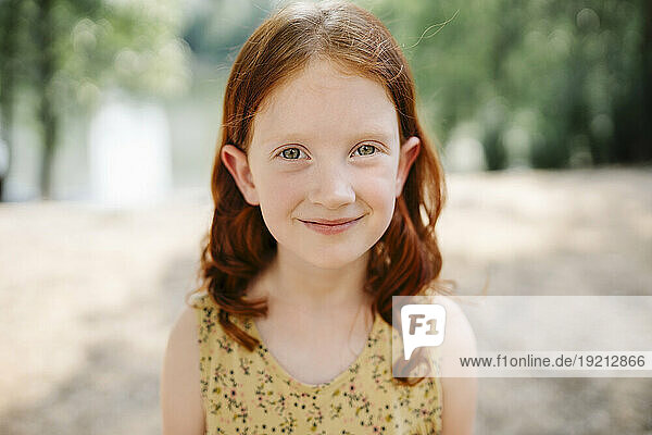 Happy redhead girl in park