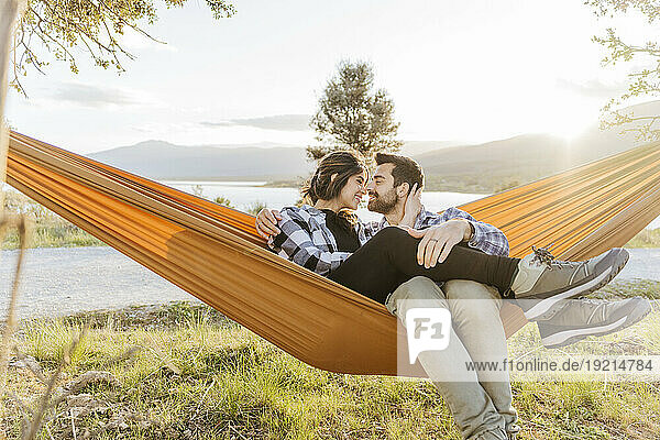 Smiling couple relaxing in hammock