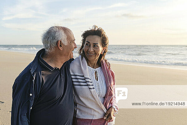 Happy man and woman together spending time at beach