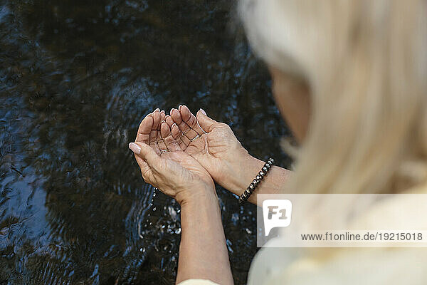 Woman with water in cupped hands