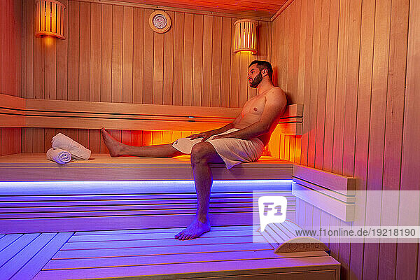 Young bearded man in sauna