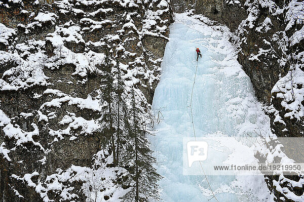 Woman Ice Climber Ascends A Large Icefall In Southcentral Alaska