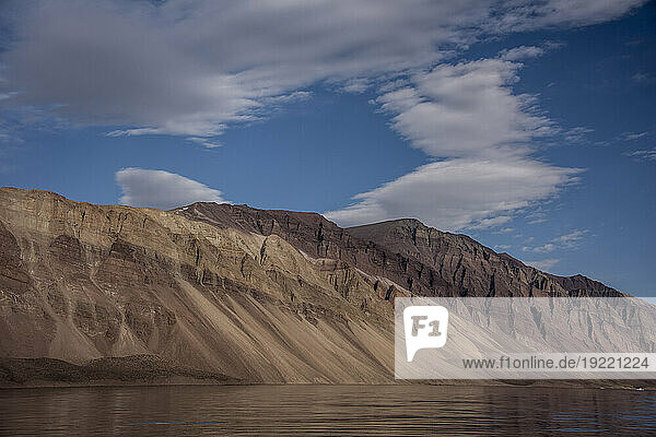 Scenic view of the silt covered mountains lining Greenland's Kaiser Franz Joseph Fjord; East Greenland  Greenland