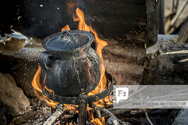 Cooking food in pot over an open flame; Ejido Hidalgo  San Luis  Mexico