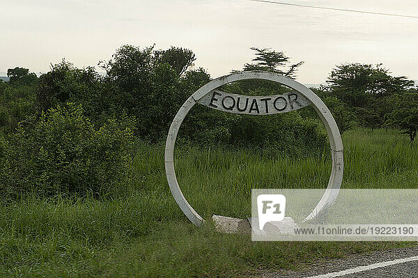 Sign marks the equatorial line along the road near Queen Elizabeth National Park in Uganda  Africa; Uganda