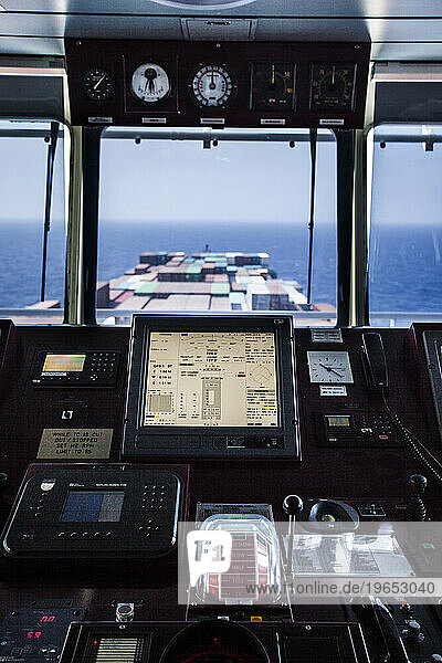 Looking out from the navigation deck of a container ship at sea.