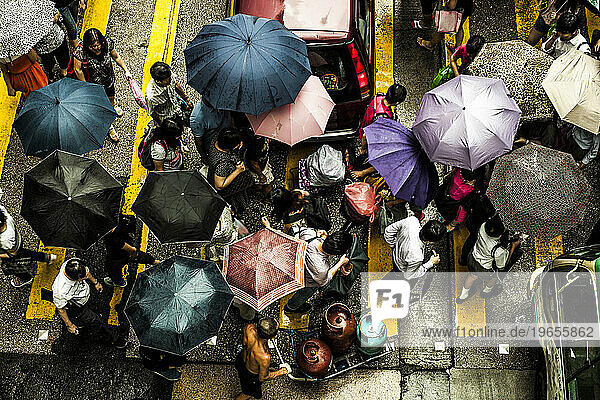 People crossing a street in the rain