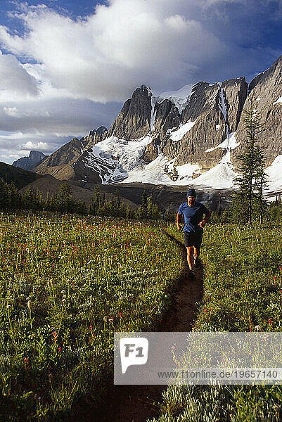 man running up trail in mountains  Canada