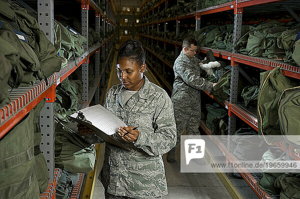 A U.S. Air Force Staff Sgt. takes inventory of the military issued gear on the deployment line.