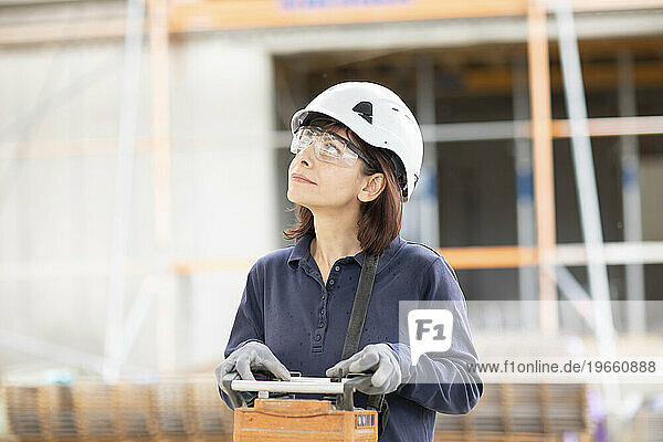 technician female controls with device construction crane