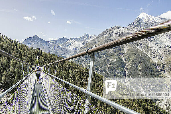 Hikers on Charles Kuonen Suspension Bridge  Valais  Switzerland