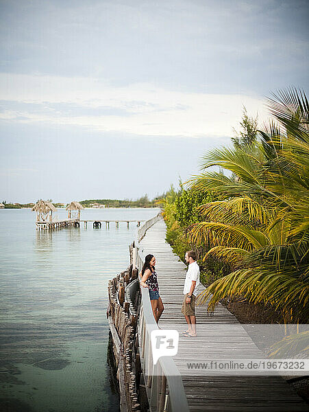 A couple enjoy the boardwalk at a small caye in Belize.