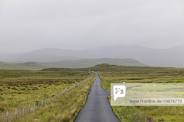 A wet road leads into the mist on the Isle of Skye  Scotland.