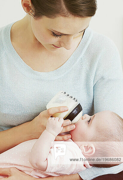 Mother Bottle Feeding Baby Girl