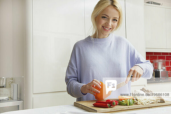 Smiling Woman Preparing Vegetables
