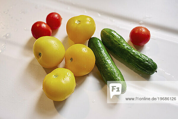 Close up still life fresh  wet cherry tomatoes and cucumber