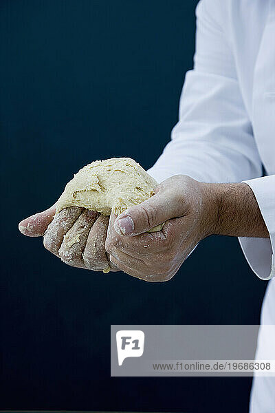 Close up of a chef hands kneading pizza dough
