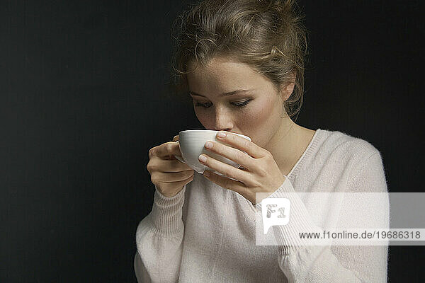 Young Woman Sipping Hot Drink