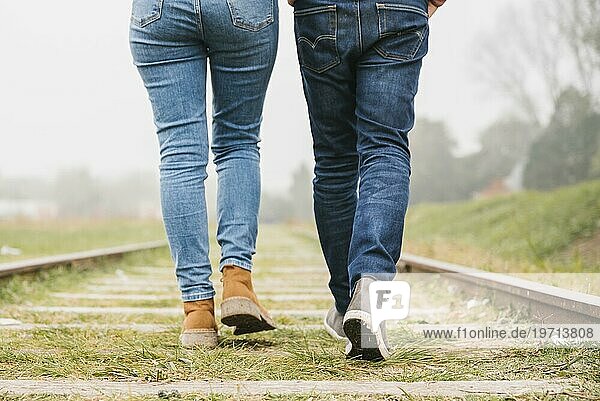 Junges Paar spaziert gemeinsam entlang der Gleise
