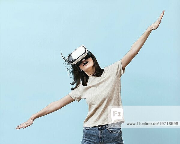 Frontansicht einer Frau  die Spaß mit einem Virtual Reality Headset hat