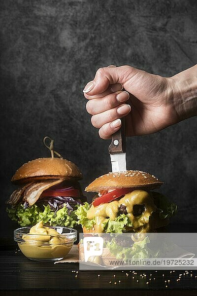 Frau hält Messer leckeren Hamburger