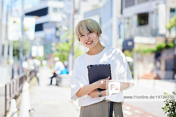 Young Japanese woman portrait downtown Tokyo