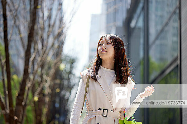Young Japanese woman walking outside