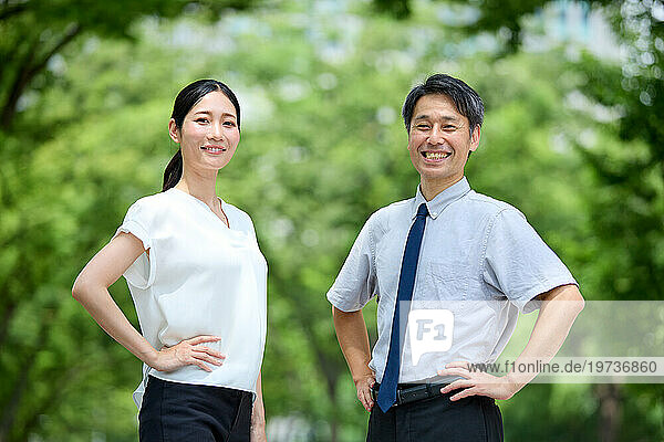 Japanese man and woman portrait in a city park
