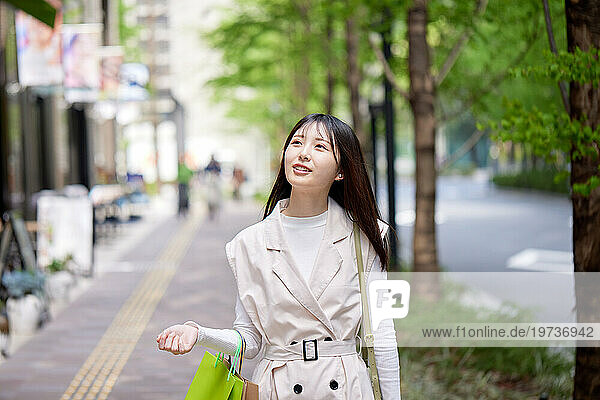 Young Japanese woman walking outside