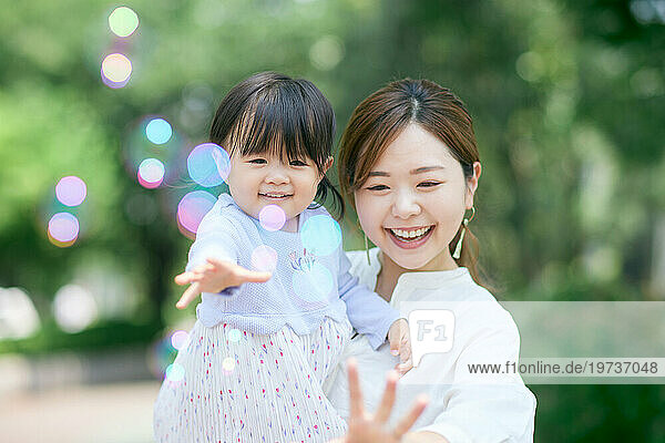 Japanese woman playing with her daughter