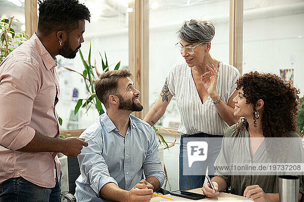 Group of coworkers brainstorming during meeting at office