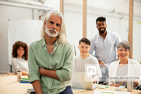 Male industrial designer looking at the camera while standing in office