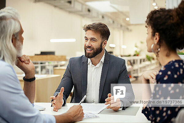Male lawyer having a meeting with clients at office
