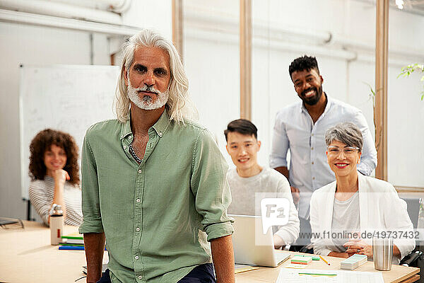 Male industrial designer looking at the camera while standing in office