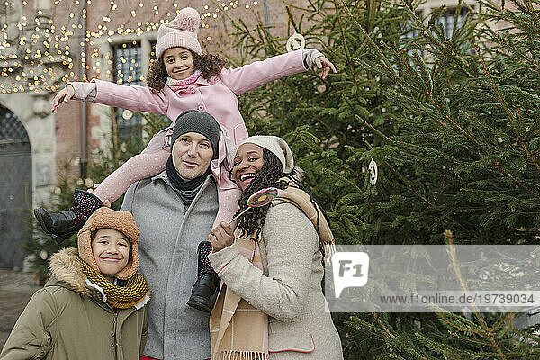 Happy family having fun together near Christmas tree