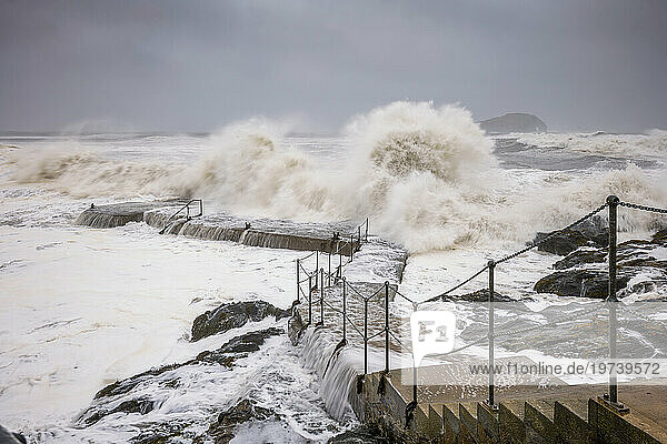UK  Scotland  North Berwick  Waves splashing against coastal steps during Storm Babet