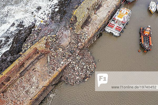 UK  Scotland  North Berwick  Aerial view of breach in harbor sea defence wall after Storm Babet