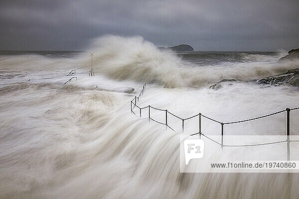 UK  Scotland  North Berwick  Long exposure of waves splashing against coastal railing during Storm Babet