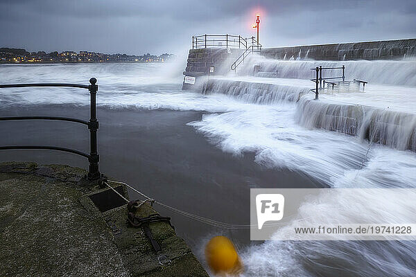UK  Scotland  North Berwick  Long exposure of waves splashing against harbor walls during Storm Babet