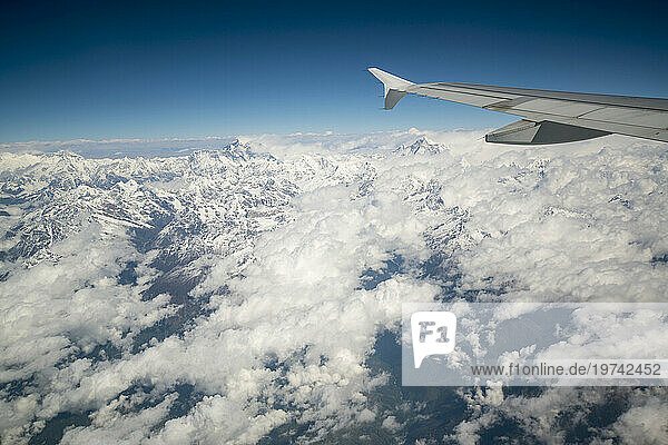 Mount Everest viewed from the window of a jet in the Himalayas; Nepal