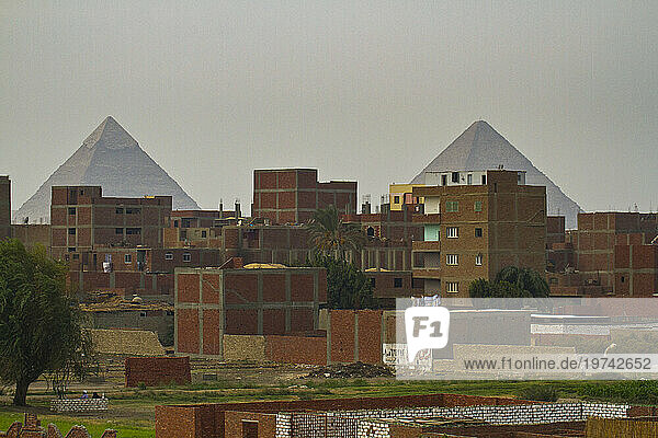 Pyramids behind the town of Giza; Giza  Egypt