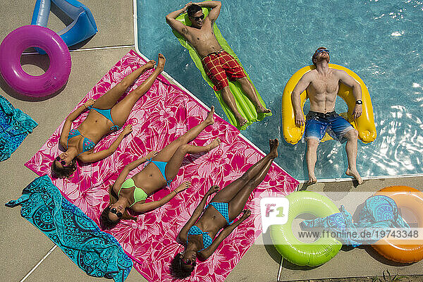 View from directly above of a group of young adult friends enjoying time at the pool on a hot day; Virginia Beach  Virginia  United States of America