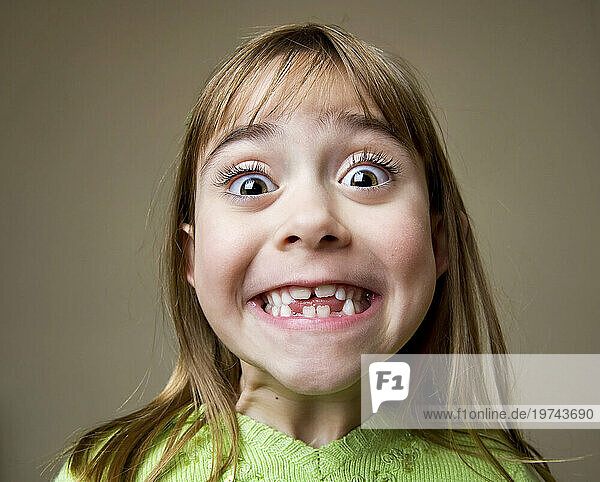 Portrait of a young girl showing her teeth; Lincoln  Nebraska  United States of America