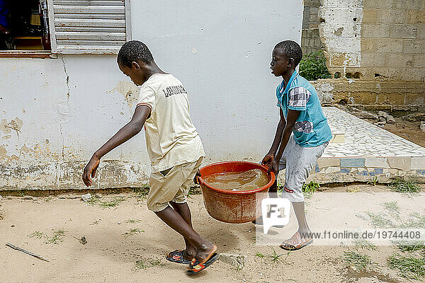 Boys fetching water in Thiaoune  Senegal  West Africa  Africa