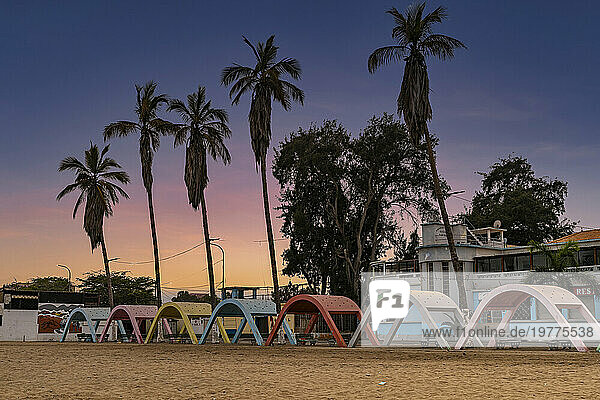Blue hour over the beach with colonial concrete beach shades in the town of Namibe  Angola  Africa
