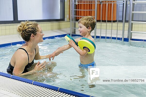 Topic: Preschool child in the swimming pool during swimming lessons in a public pool